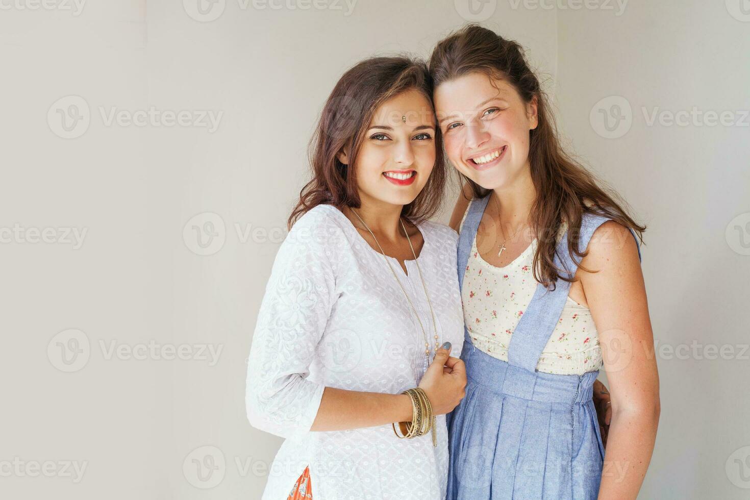 friendship of the religions concept muslim and christian girl together photo