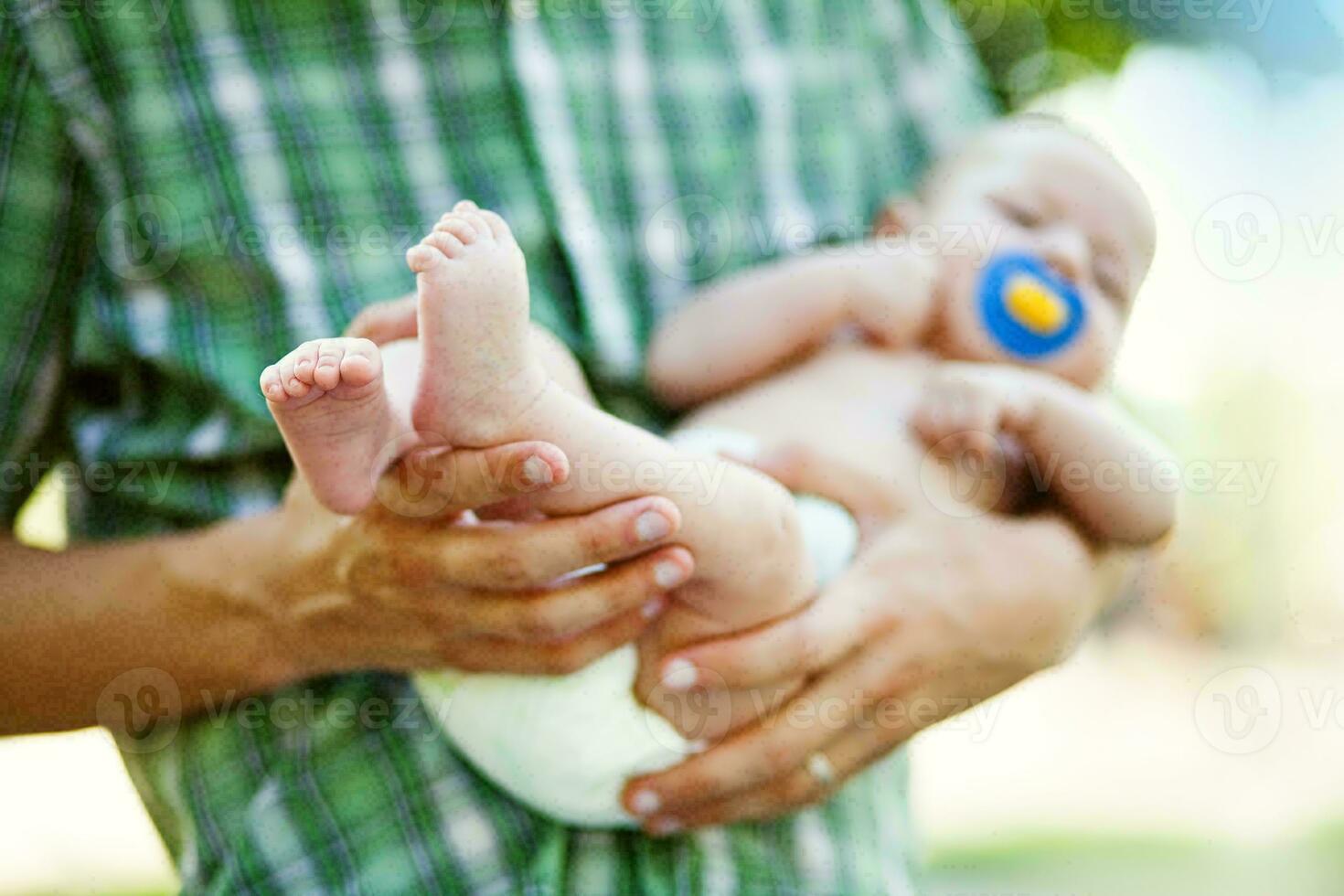 a man holding a baby in his arms photo