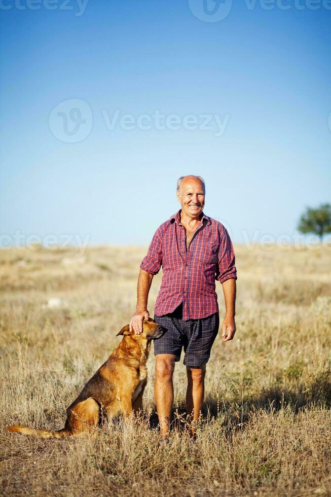 a man and his dog in a field photo