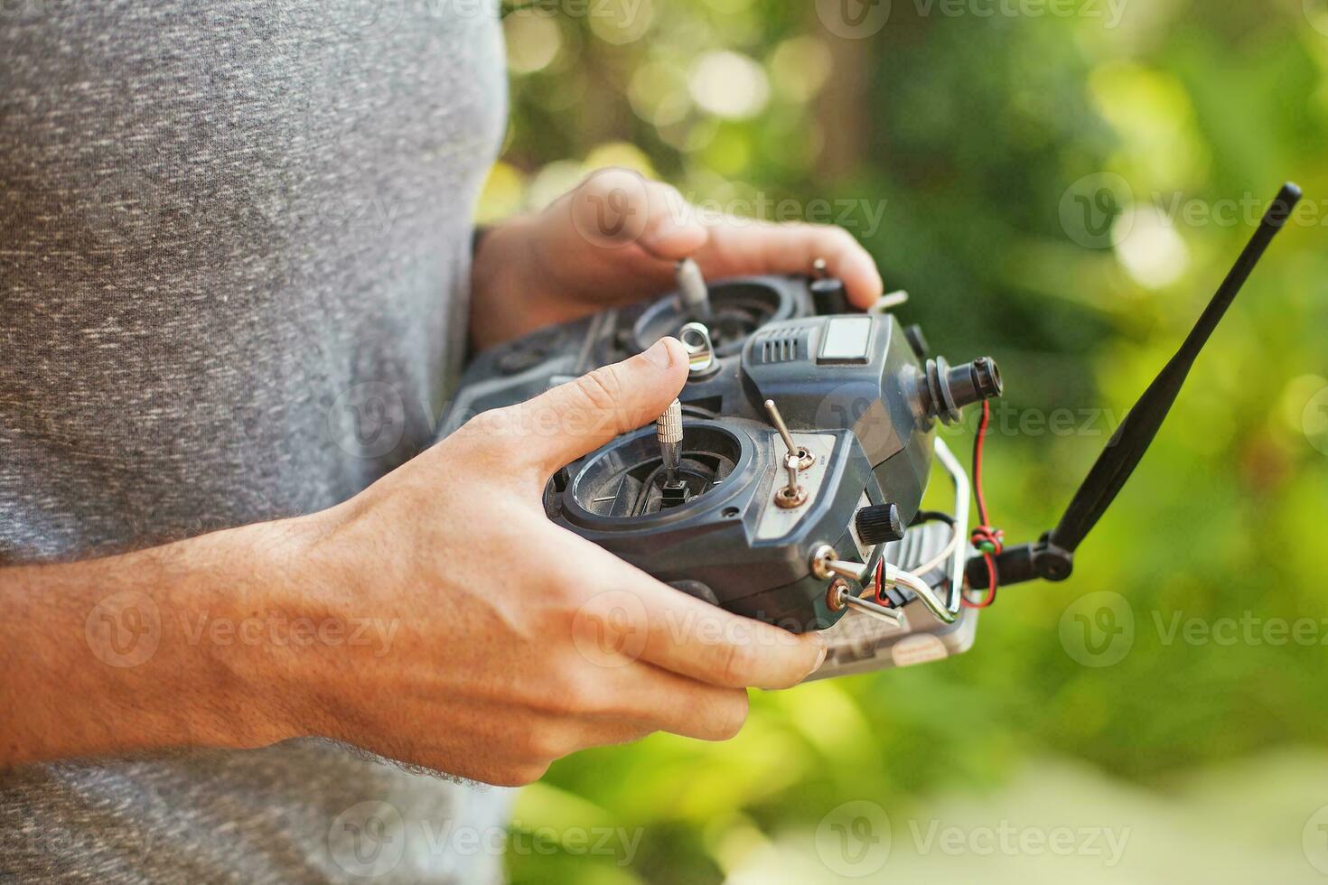 a man holding a remote control in his hand photo