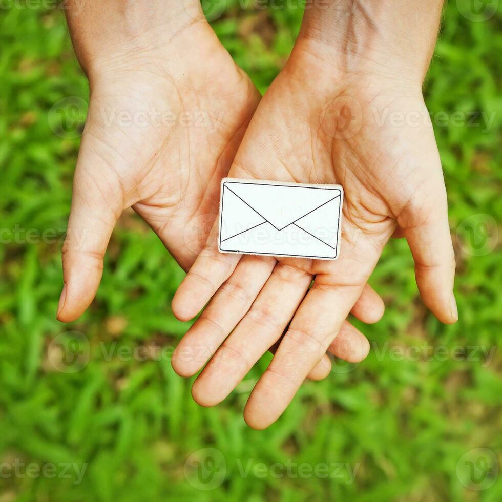 hands holding an envelope with a white envelope photo