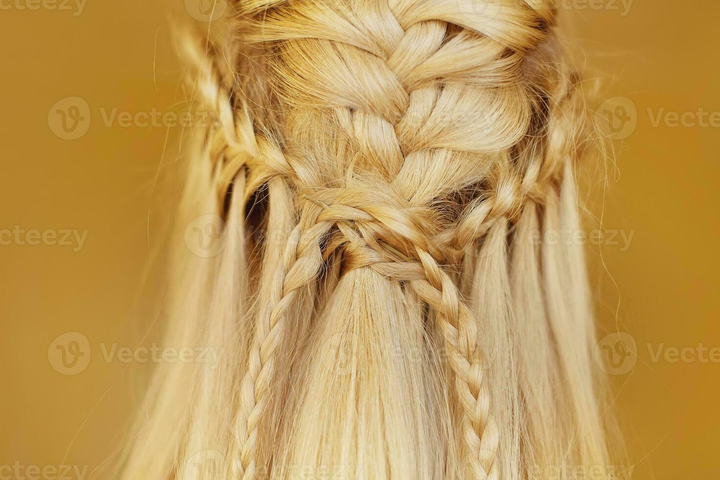 a woman with long blonde hair is braided into a braid photo