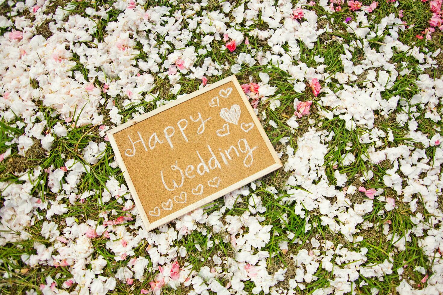 wedding card on the ground with flowers photo