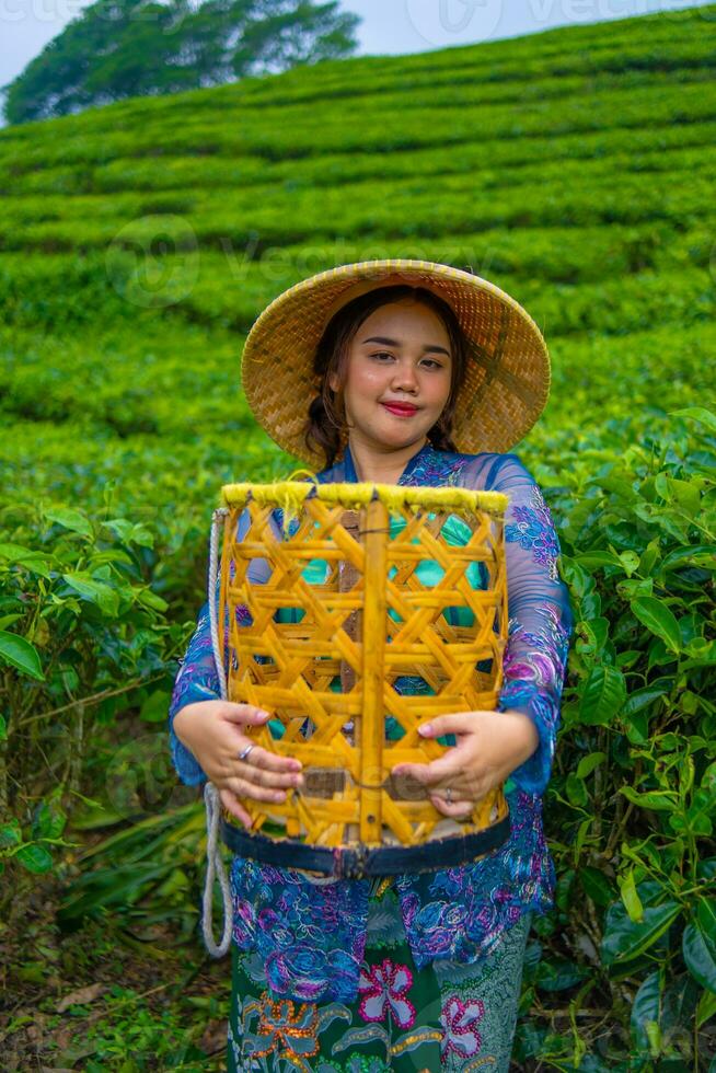 an Asian farmer holding a bamboo basket with a cheerful smiling face photo