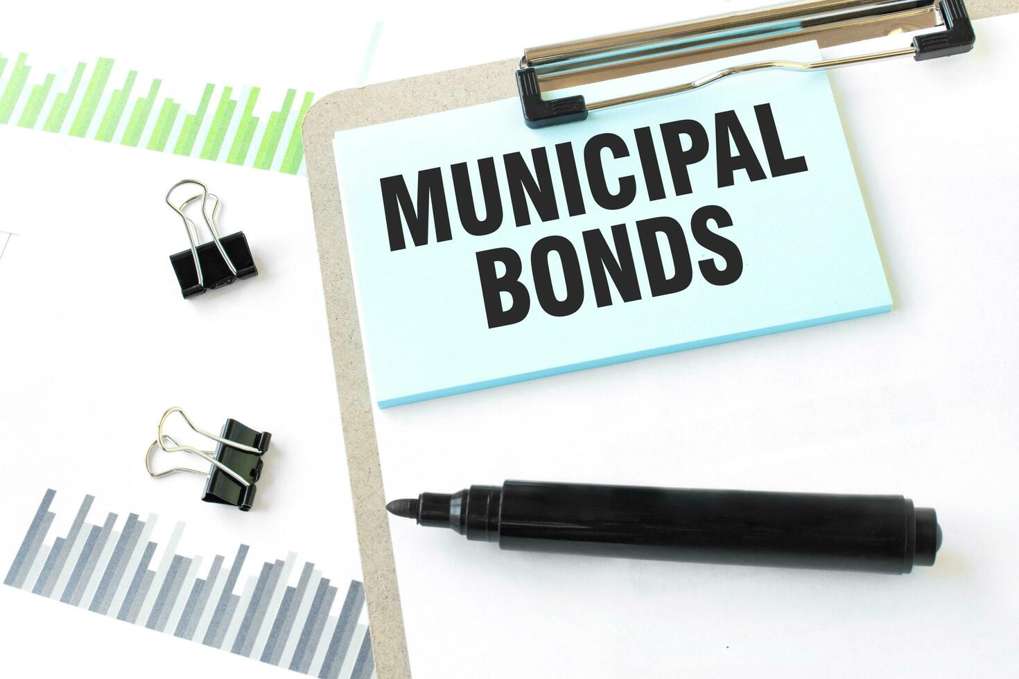 Paper plate, marker, diagram, chart and office tools. Text MUNICIPAL BONDS photo