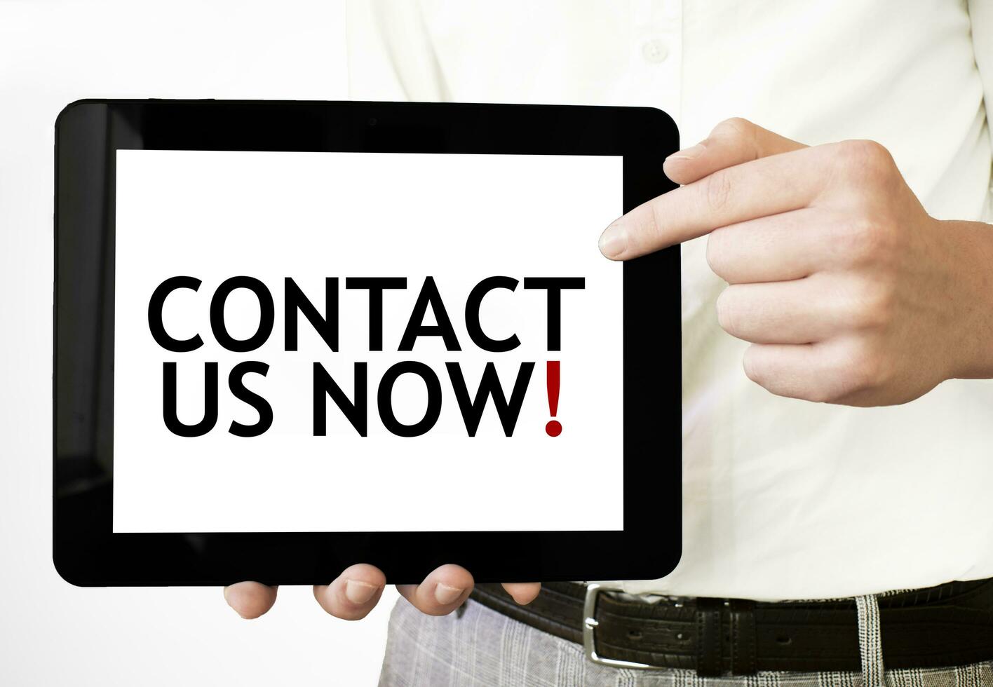 Text CONTACT US NOW on tablet display in businessman hands on the white background. Business concept photo