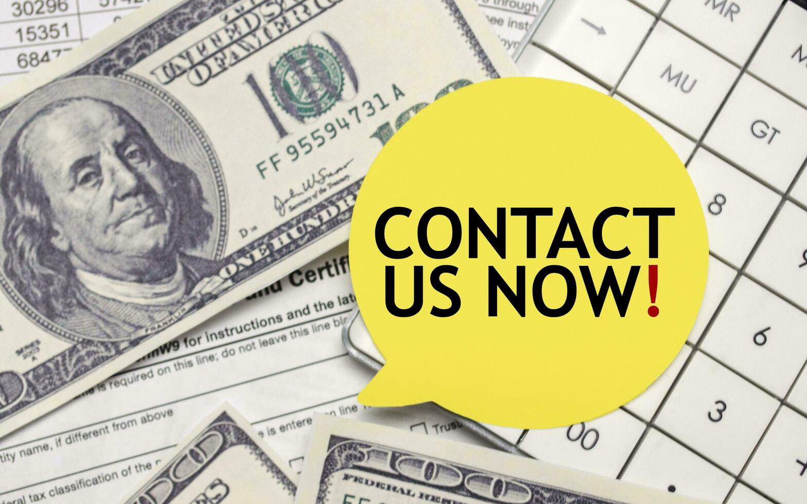 CONTACT US NOW words on yellow sticker with dollars and charts photo