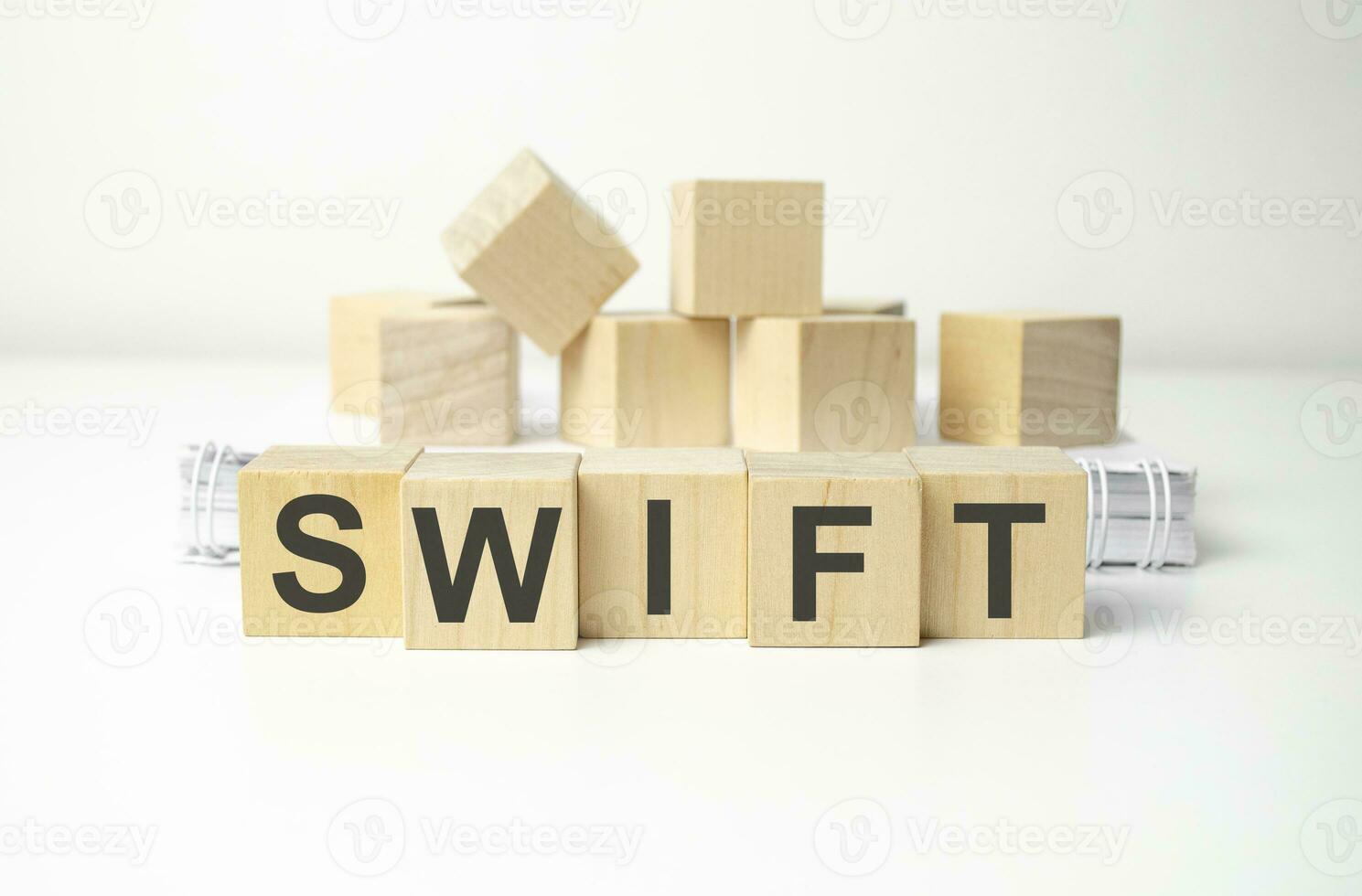 wooden cube block with swift business word on table background. photo