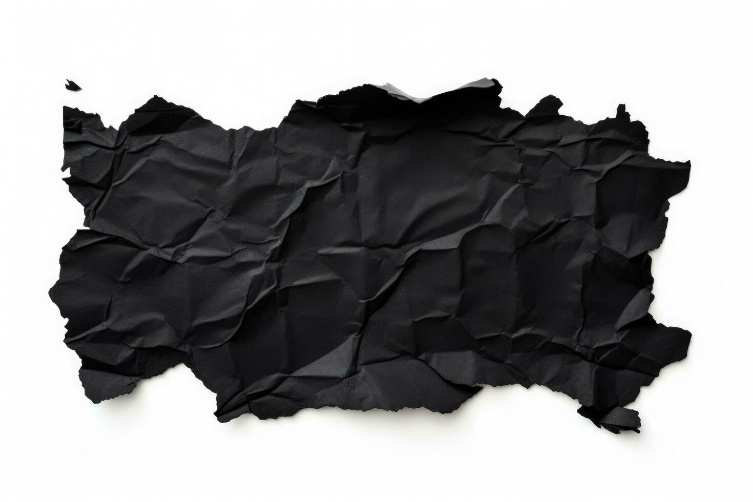 Black torn paper piece isolated on white background photo