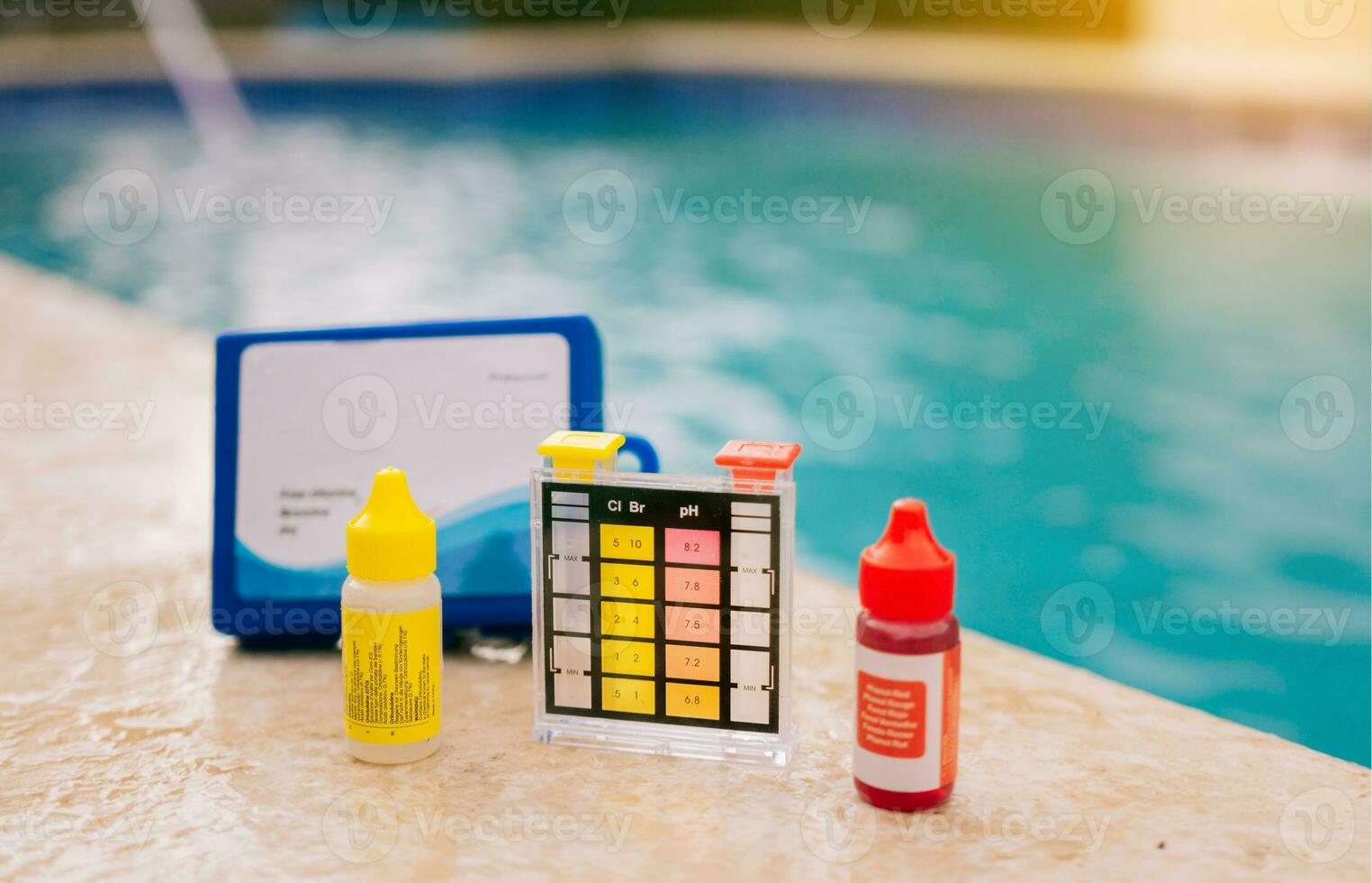 Chlorine and ph tester for swimming pools, Chlorine test kit on the edge of the pool. PH tester for pool maintenance. Water test kit for swimming pools photo