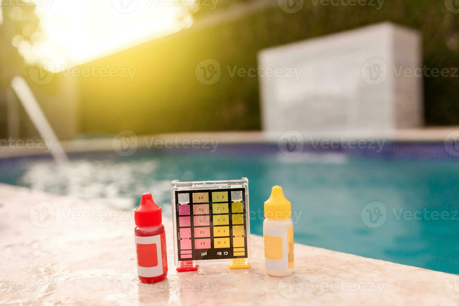 Water test kit for swimming pools, Chlorine and ph tester for swimming pools. Chlorine test kit on the edge of the pool,  Mini tester for pool maintenance photo