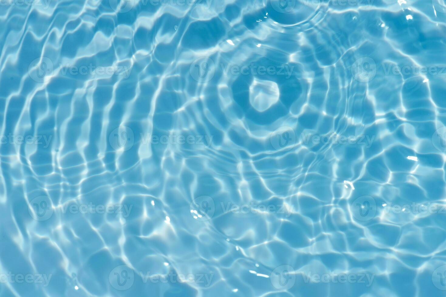 Blue water with ripples on the surface. Defocus blurred transparent blue colored clear calm water surface texture with splashes and bubbles. Water waves with shining pattern texture background. photo