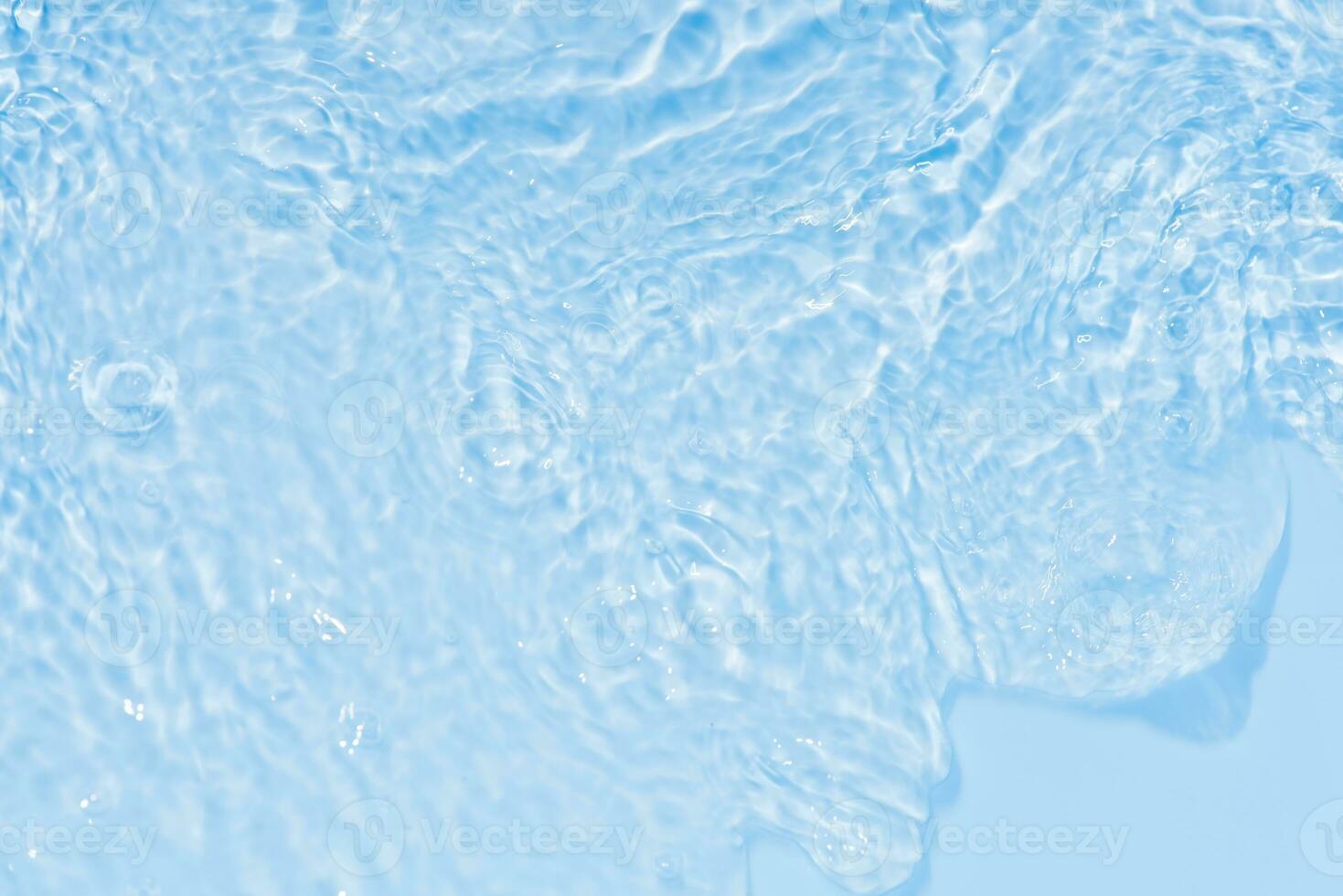 Blue water with ripples on the surface. Defocus blurred transparent blue colored clear calm water surface texture with splashes and bubbles. Water waves with shining pattern texture background. photo