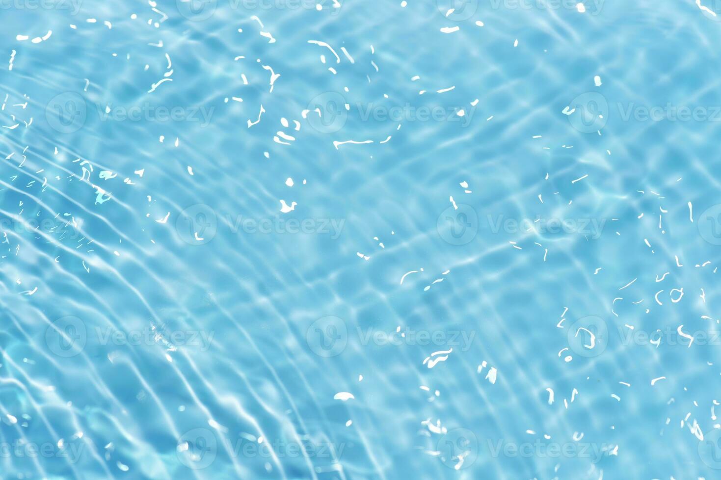 Blue water with ripples on the surface. Defocus blurred transparent blue colored clear calm water surface texture with splashes and bubbles. Water waves with shining pattern texture background. photo