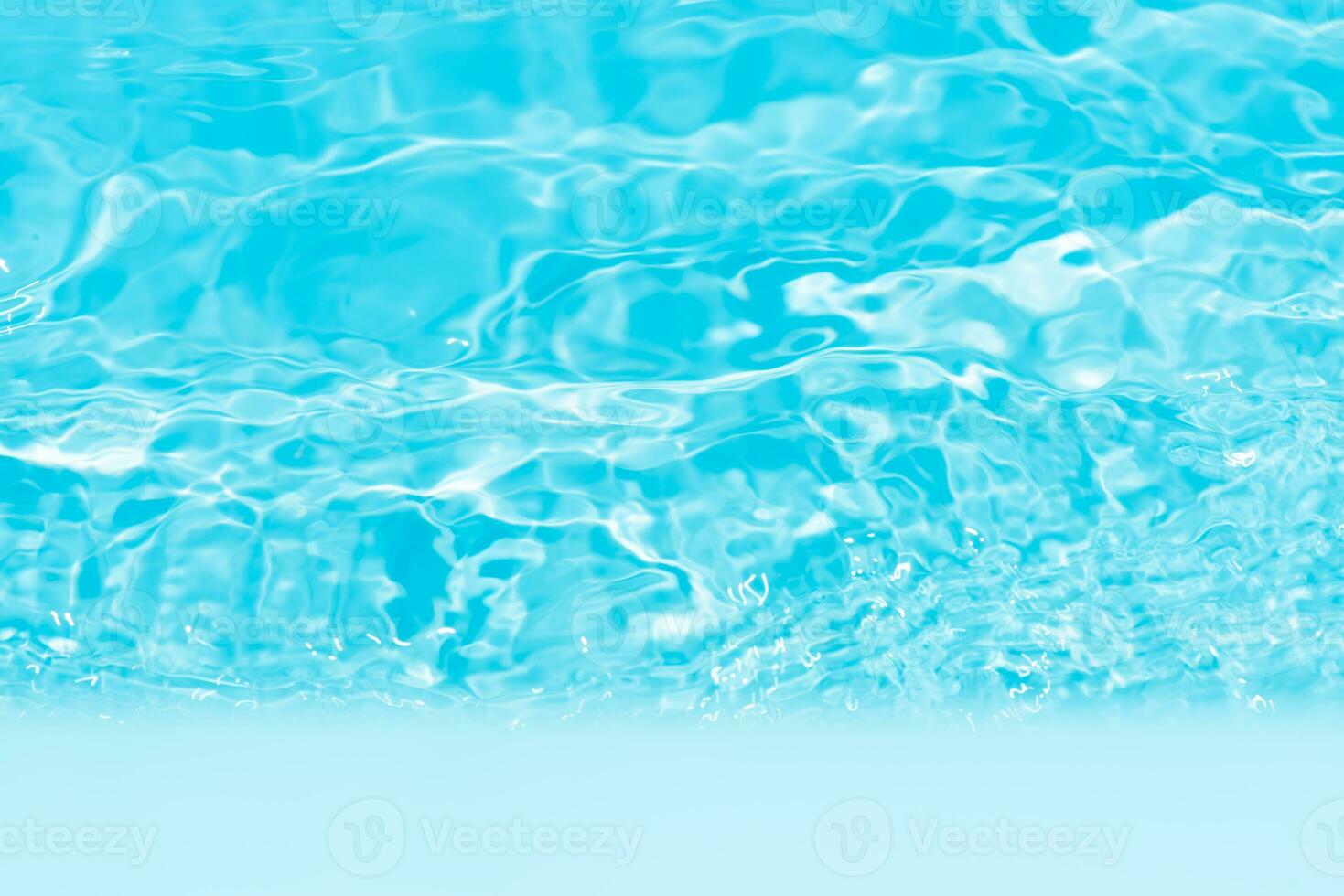 Blue water with ripples on the surface. Defocus blurred transparent blue colored clear calm water surface texture with splashes and bubbles. Water waves with shining pattern texture background. photo