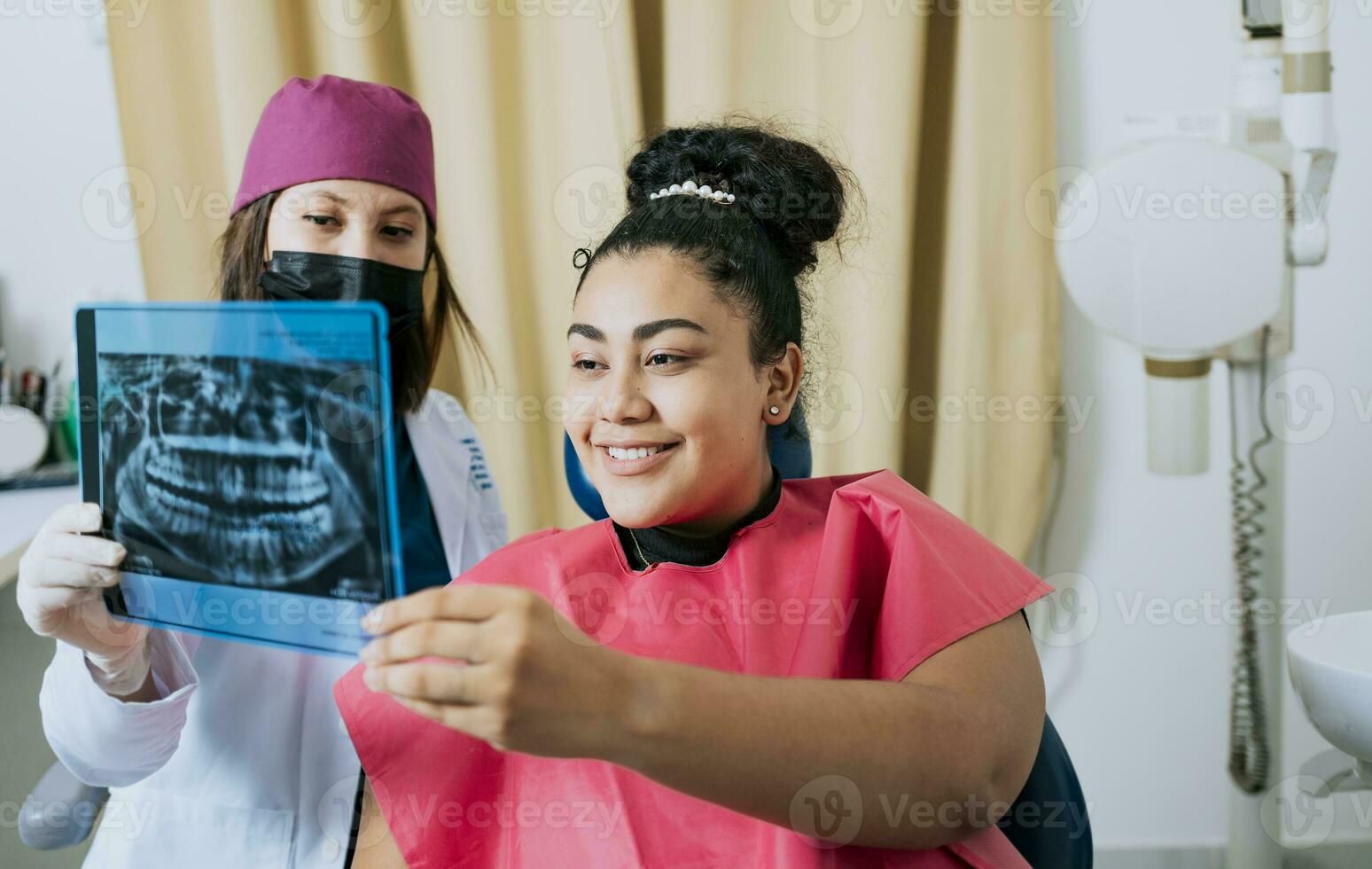 Patient looking at x-ray with dentist, Concept of dentist showing x-ray examination to female patient, Dentist showing patient x-ray. Dentist with patient reviewing the x-ray photo