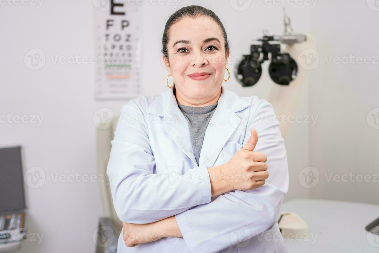 Optometry specialist with thumb up. Smiling eye doctor with thumb up in office, Female optometrist with thumb up in the laboratory photo