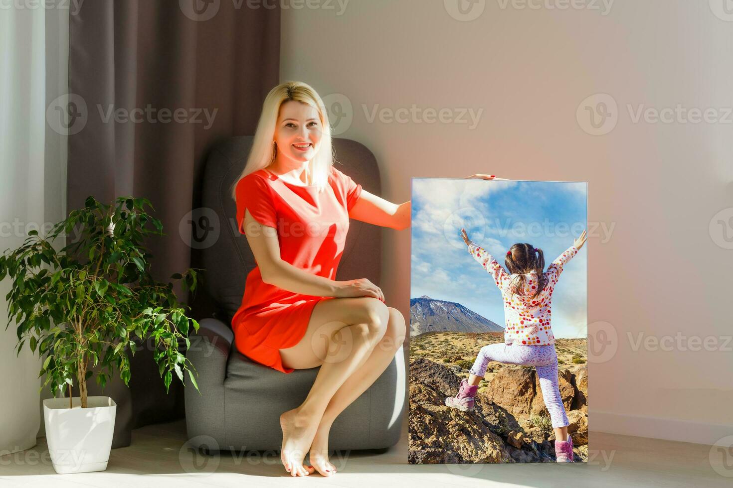 Canvas prints. A woman holding photo canvas. photo printed on glossy synthetic canvas and stretched on wooden stretcher bar