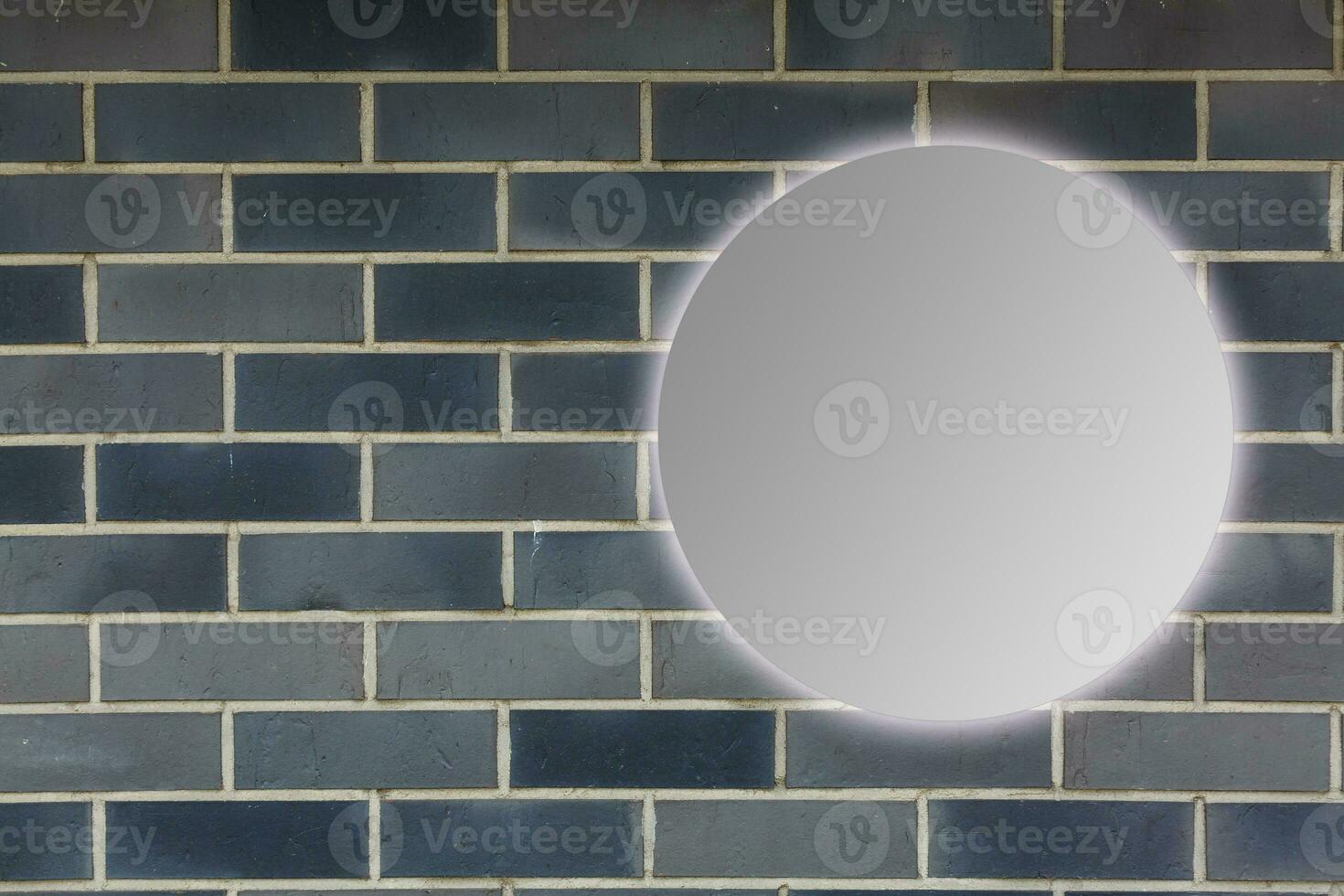 Round mirror near brick wall photo