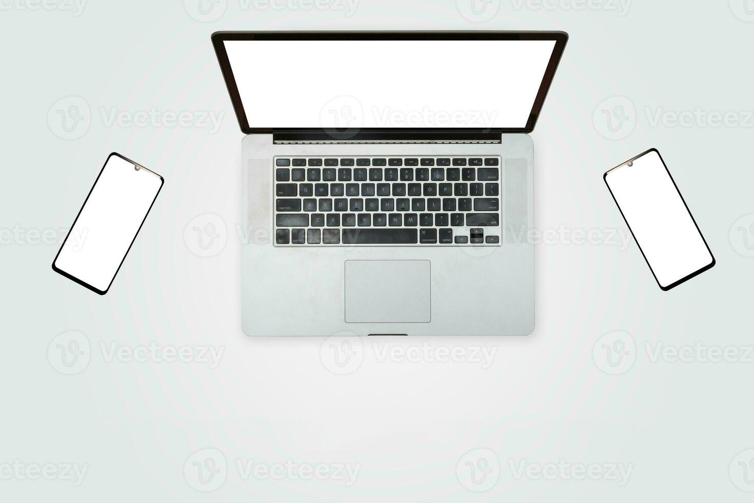 Open laptop with white smartphone. All with isolated screen on white background desk. photo