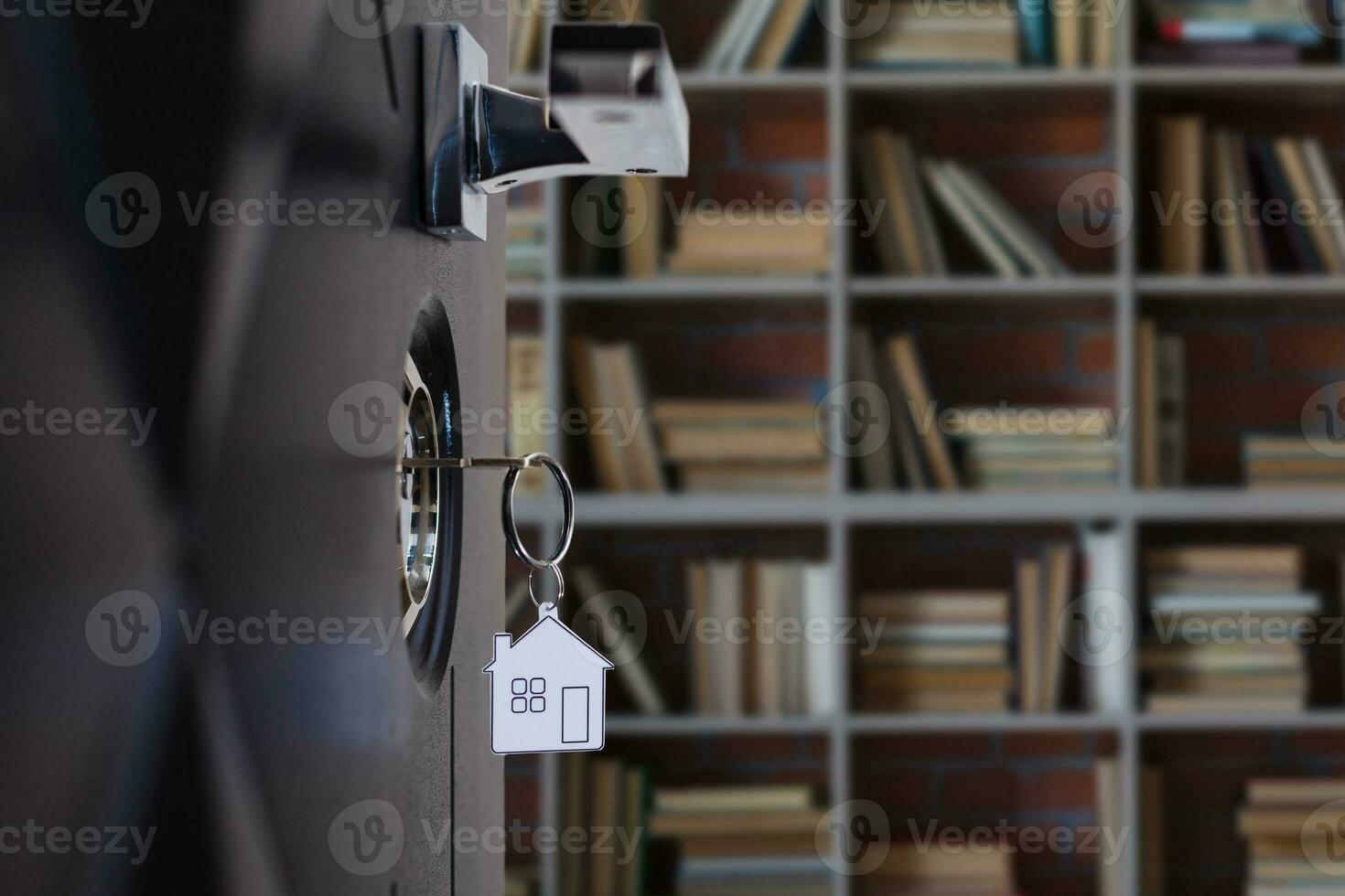 A key in a lock with house icon on it photo