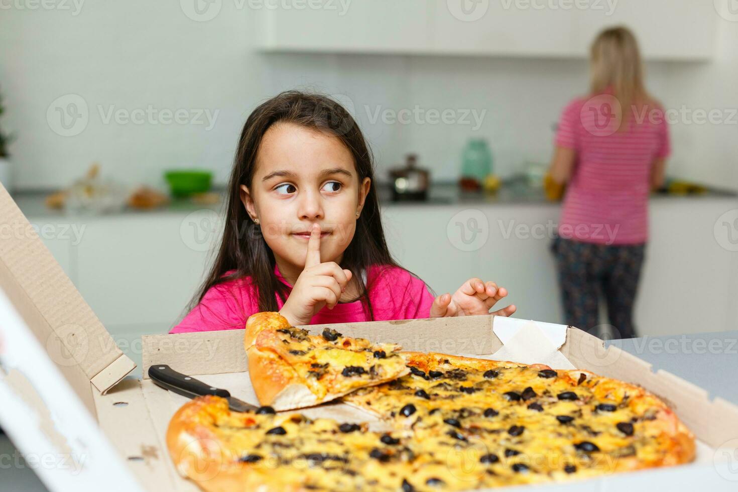 Little girl eating pizza photo