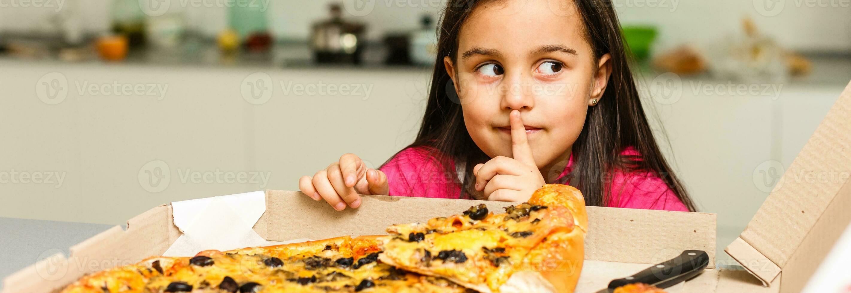 Little girl eating pizza photo