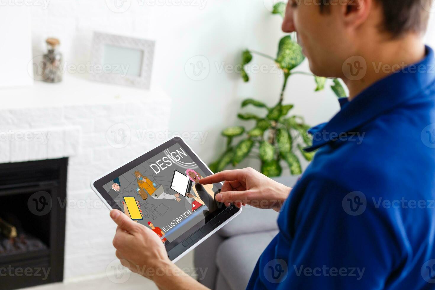 Man hand working with tablet illustration project at home while relaxing on couch. Back view of latin architect reading illustration on digital tablet. photo