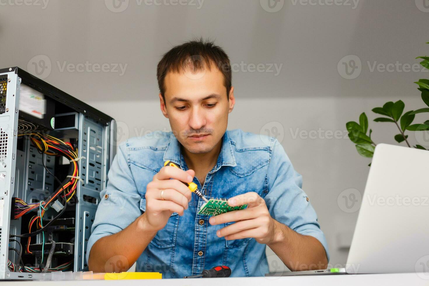 Computer engineer working on broken console in his office photo