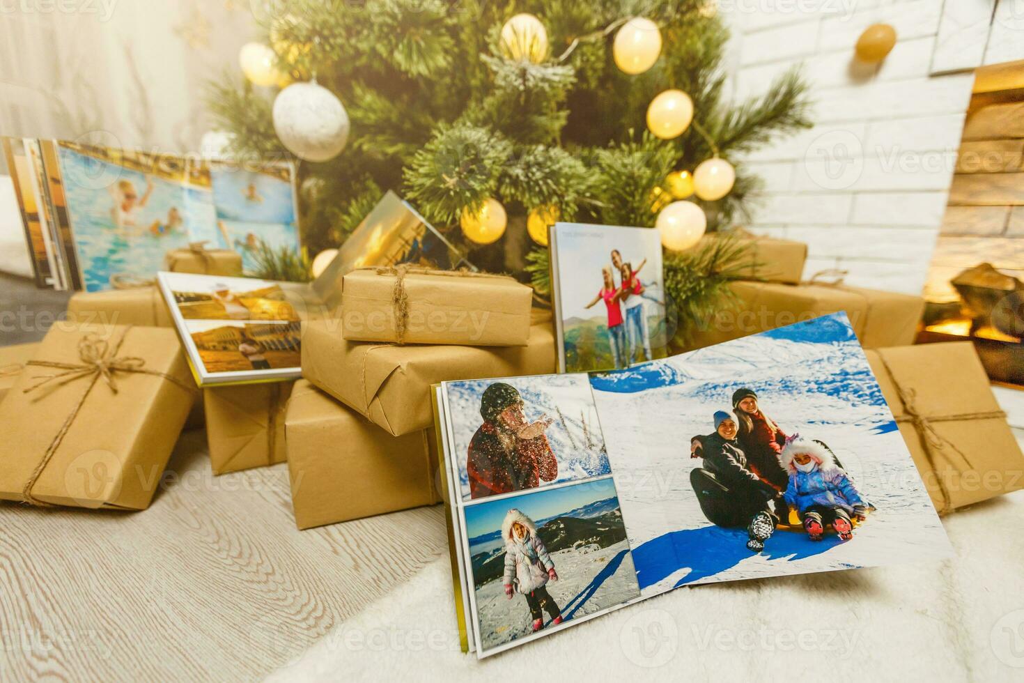 book together near Christmas tree in front of fireplace photo