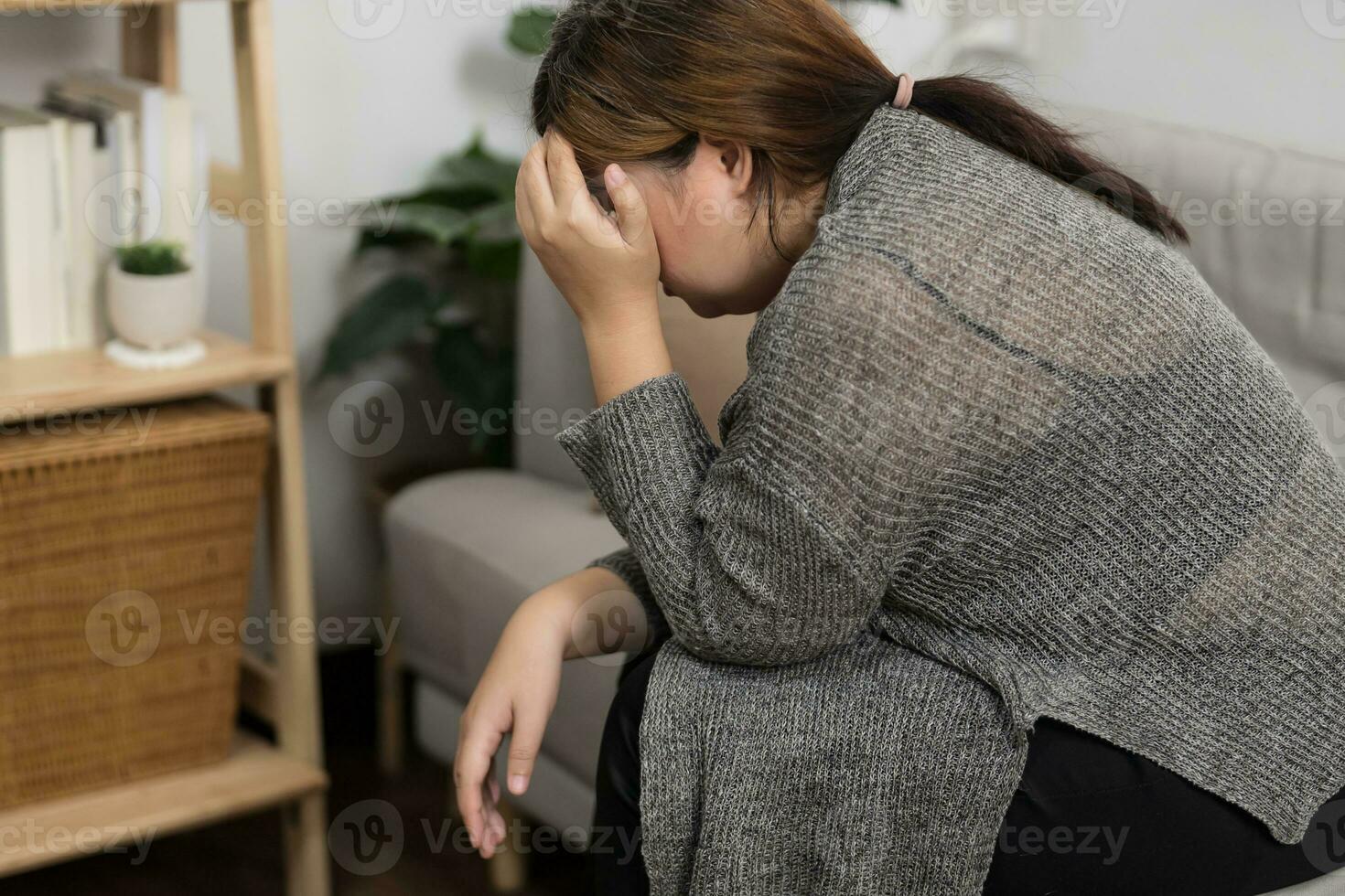Sad Overweight plus size woman thinking about problems on sofa upset girl feeling lonely and sad from bad relationship or Depressed woman disorder mental health. photo