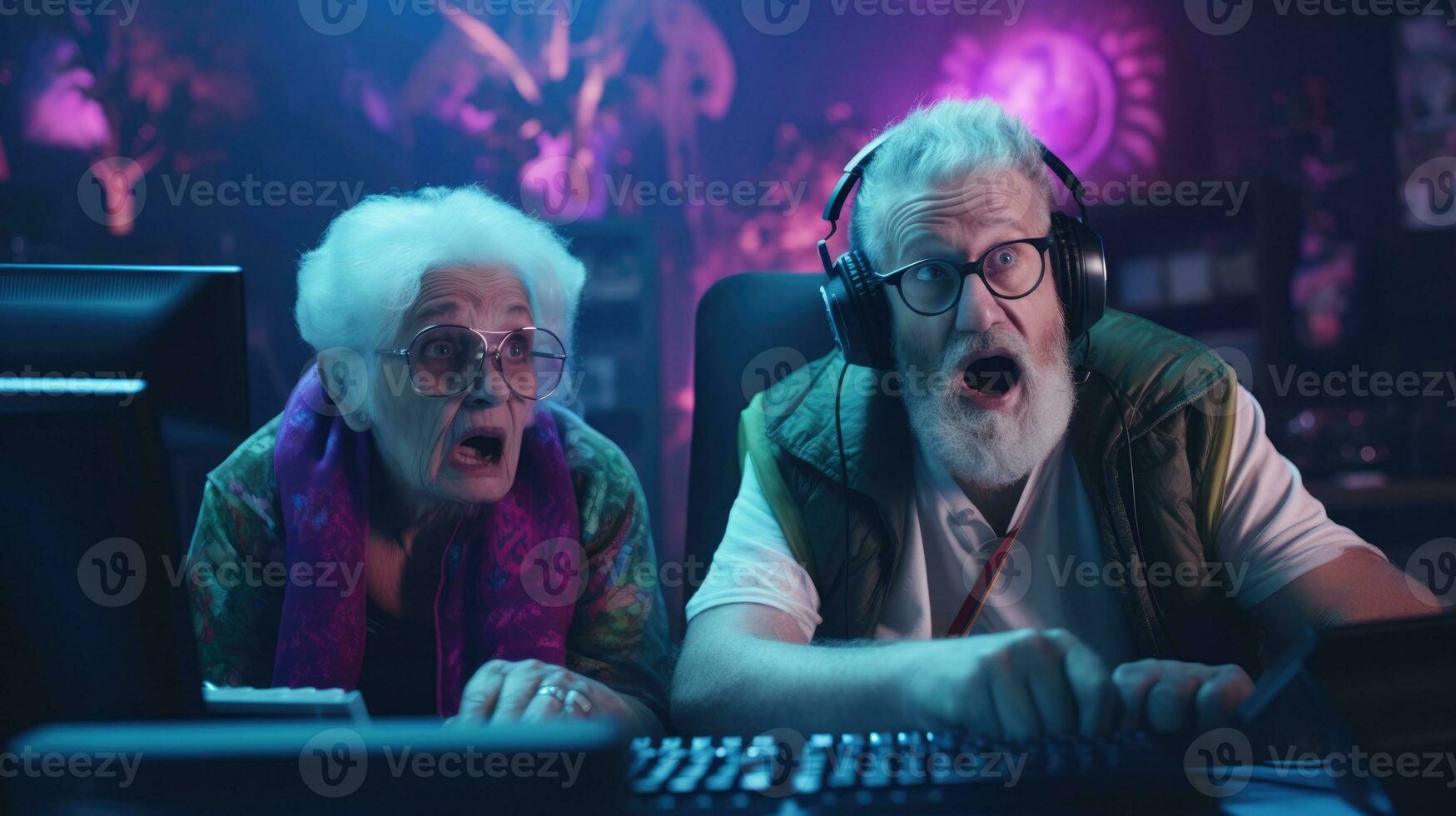 Funny elderly couple are playing computer games. Old gamers in a computer club. photo