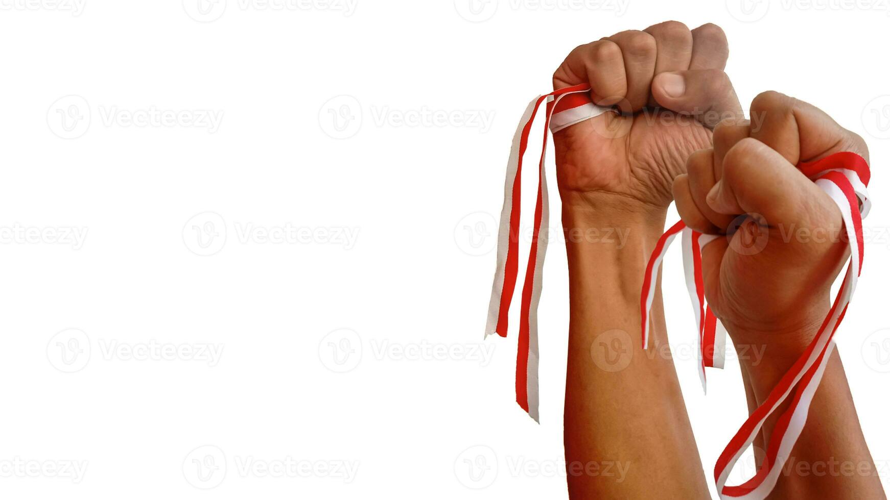 The hands of a man holding a red and white ribbon as a symbol of the Indonesian flag. Isolated on white background photo