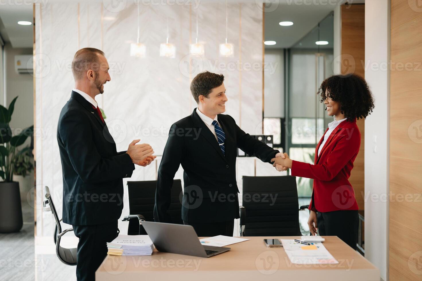 business people shaking hands during a meeting in modern office photo