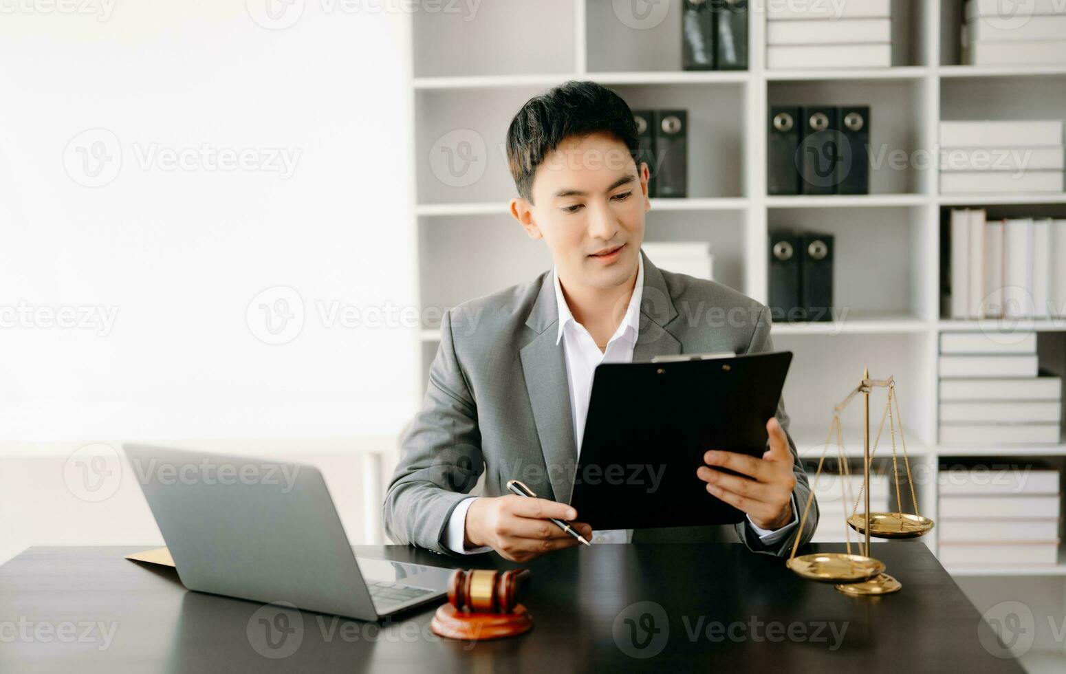 justice and law concept .Asian Male judge in a courtroom on table and Counselor working in office. photo