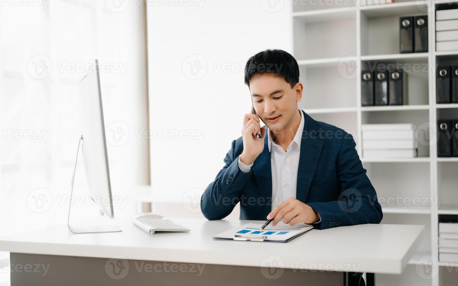 Business man using tablet and laptop for doing math finance on an office desk, tax, report, accounting, statistics, and analytical research concept in office photo