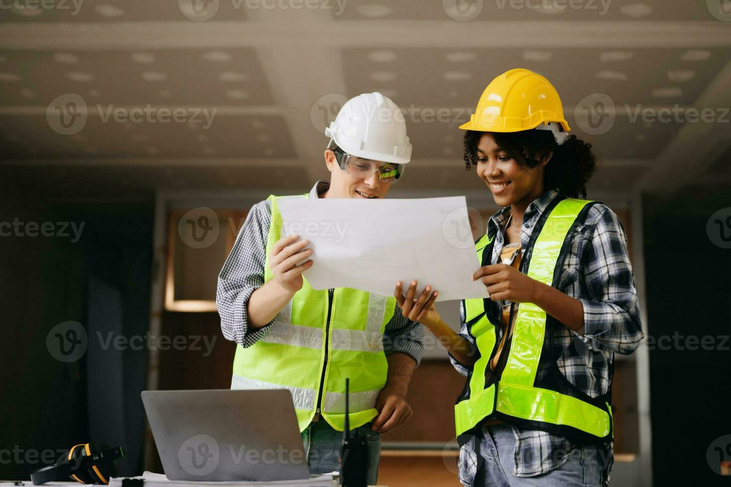 Architect caucasian man and woman working with colleagues mixed race in the construction site. Architecture engineering on big project. Building in construction process interior. photo