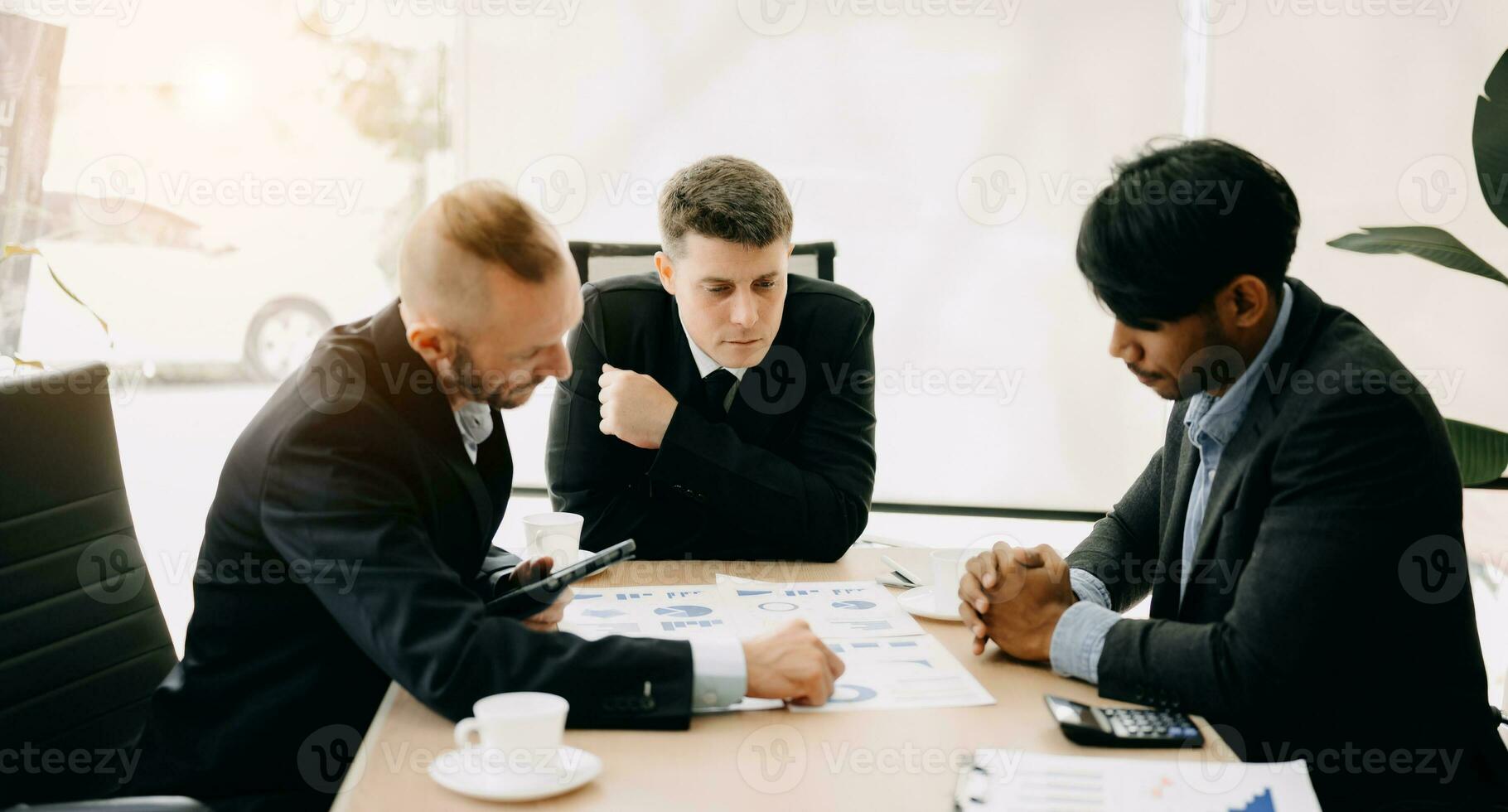 Business team discuss at meeting room. working together with laptop ,tablet and smart phone on desk Financial accountant , planner , meeting , introduction concept. At office photo