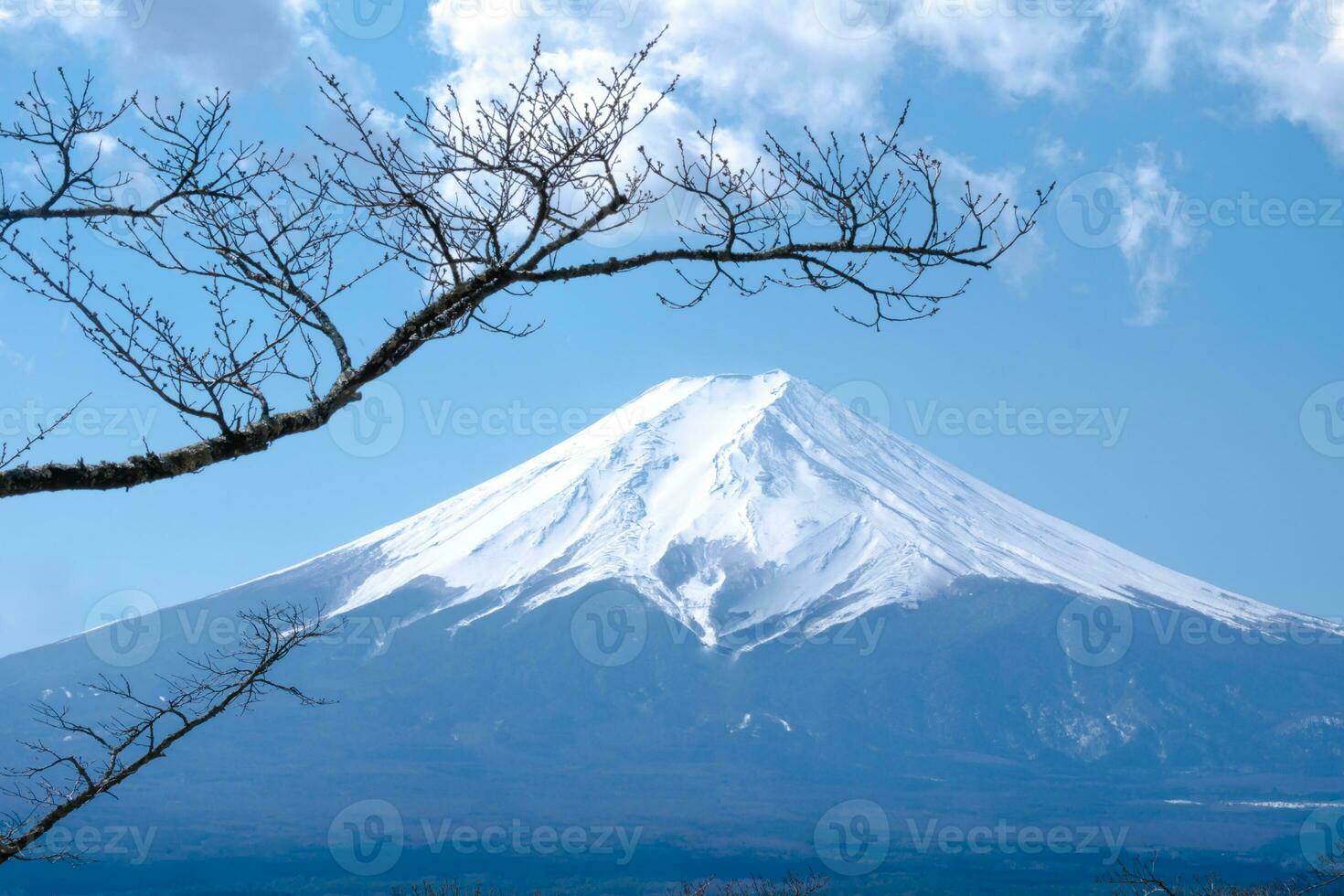 Mountain Fuji of snow on top in japan with blue sky and clouds view background photo