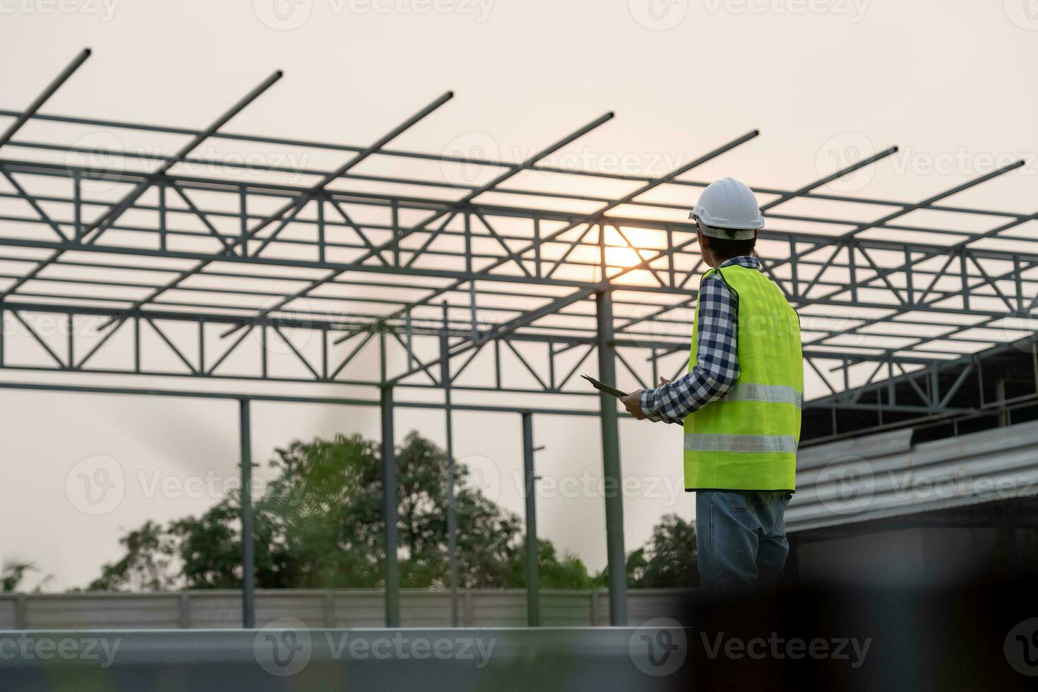 inspector or engineer is inspecting construction and quality assurance new house using a checklist. Engineers or architects or contactor work to build the house before handing it over to the homeowner photo
