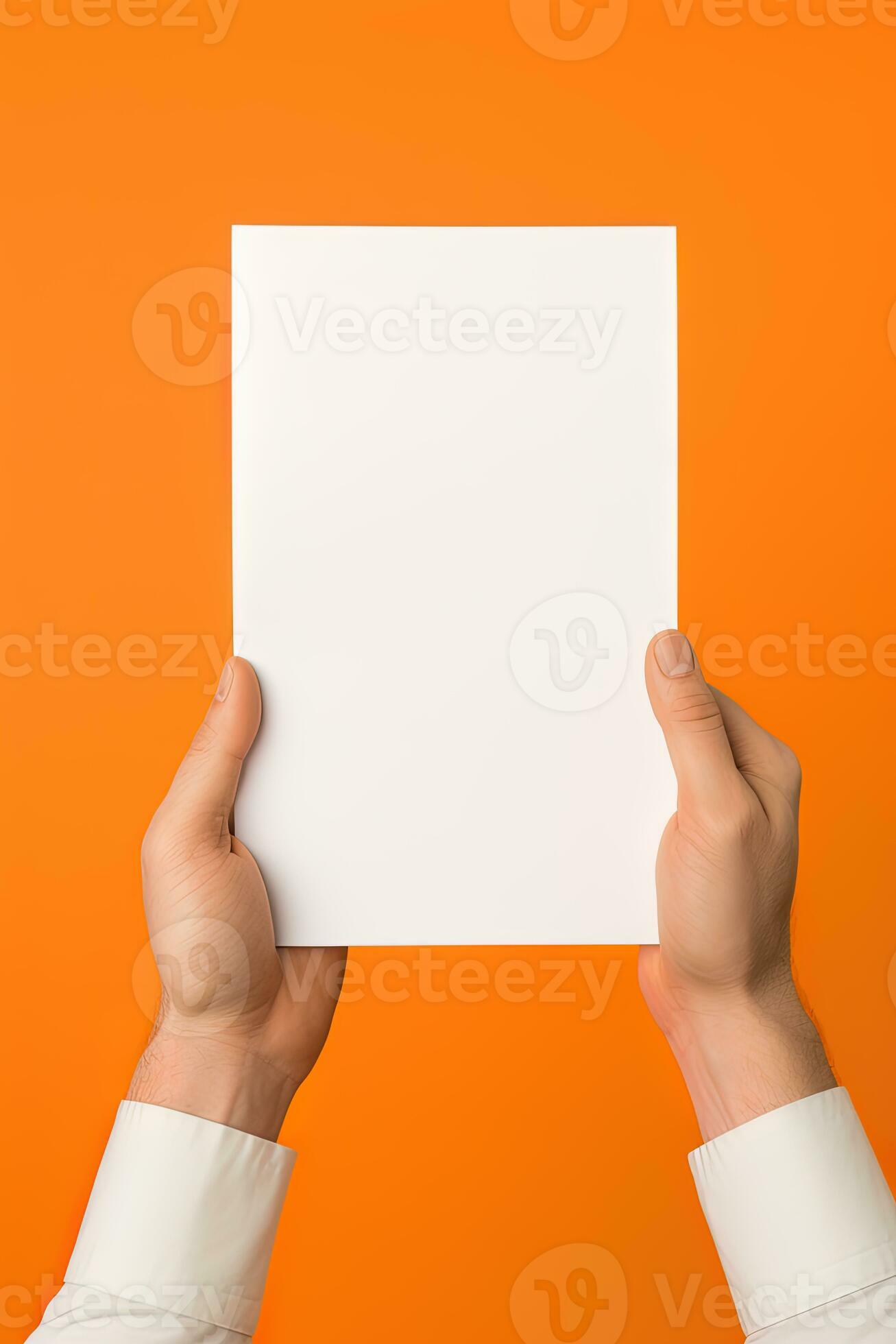 A human hand holding a blank sheet of white paper or card isolated on