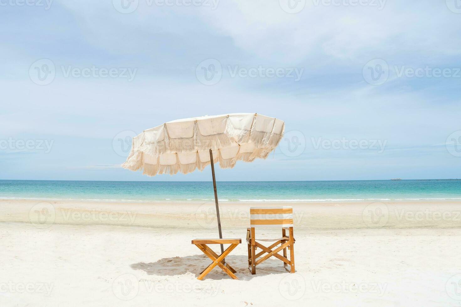 Beach umbrellas and chairs with white sand and perfect blue sky. photo