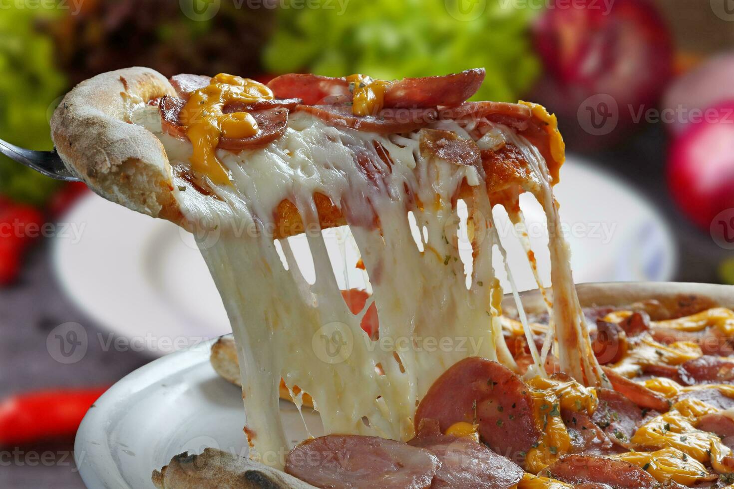 Slice of melting mozzarella pizza photo