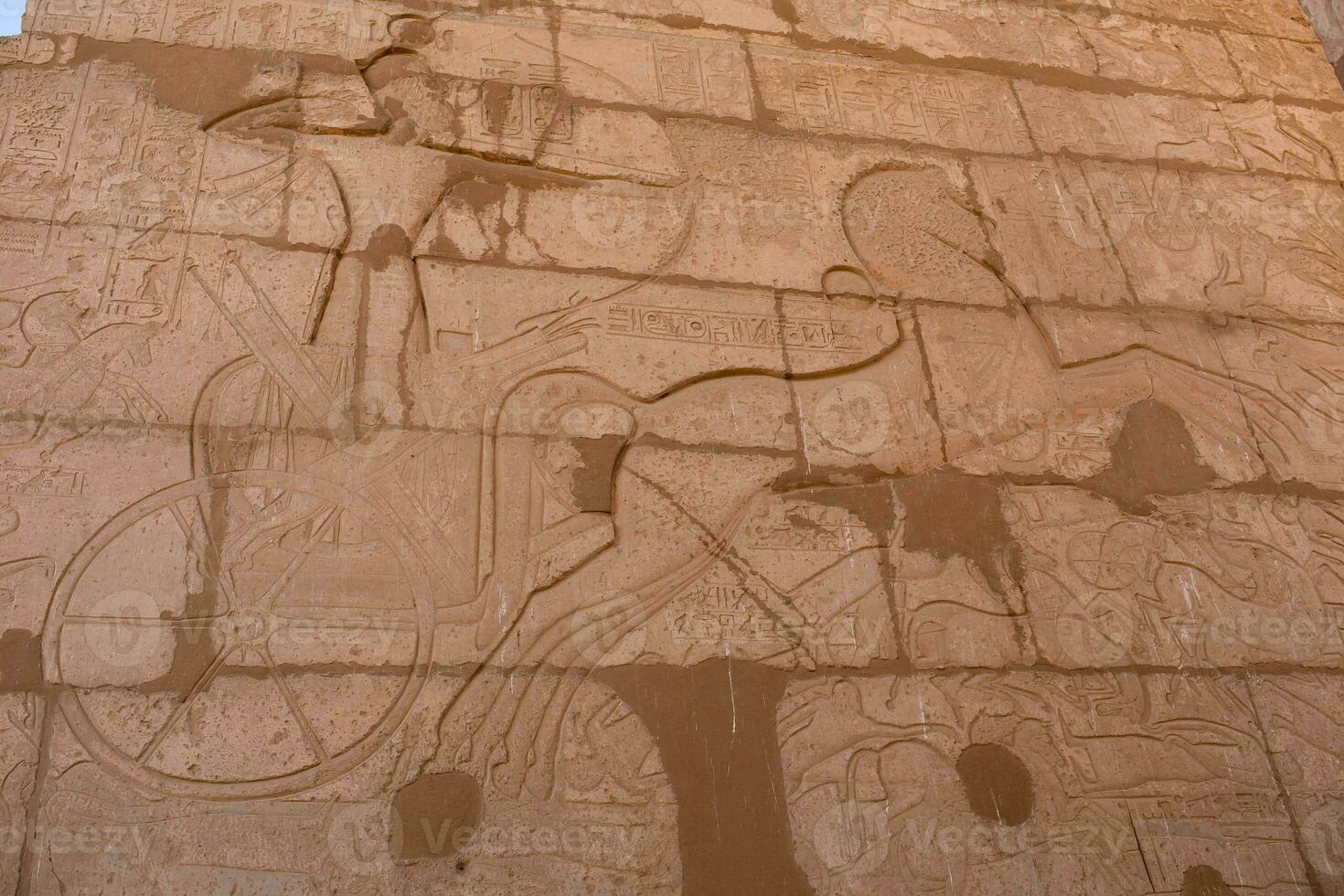 a large stone wall with carvings on it photo