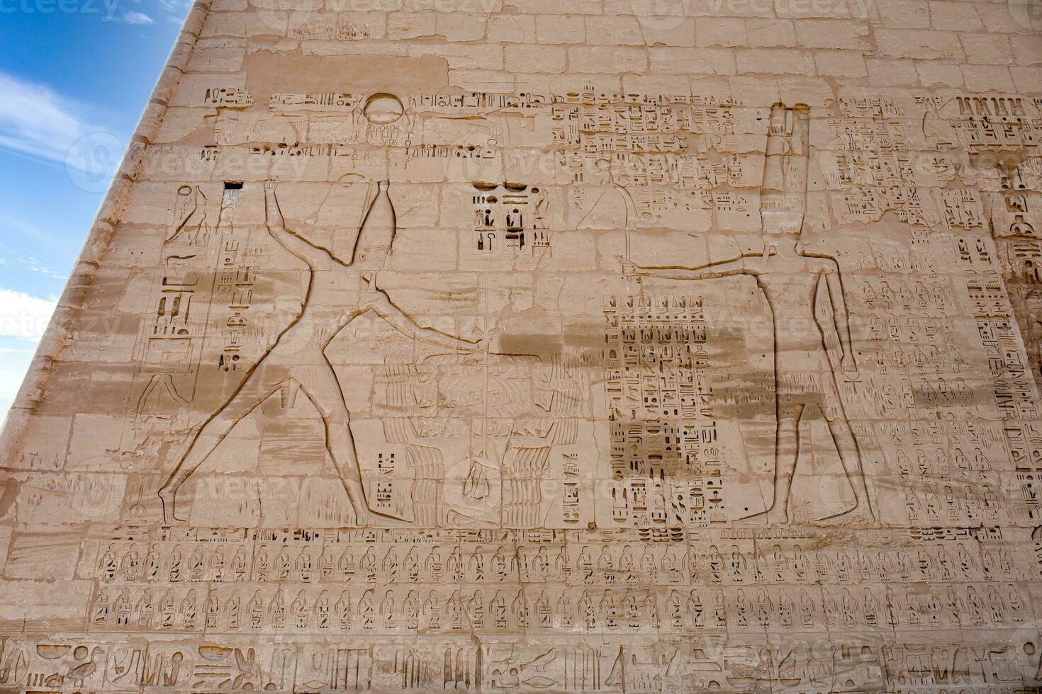 a large stone wall with hieroglyphics on it photo