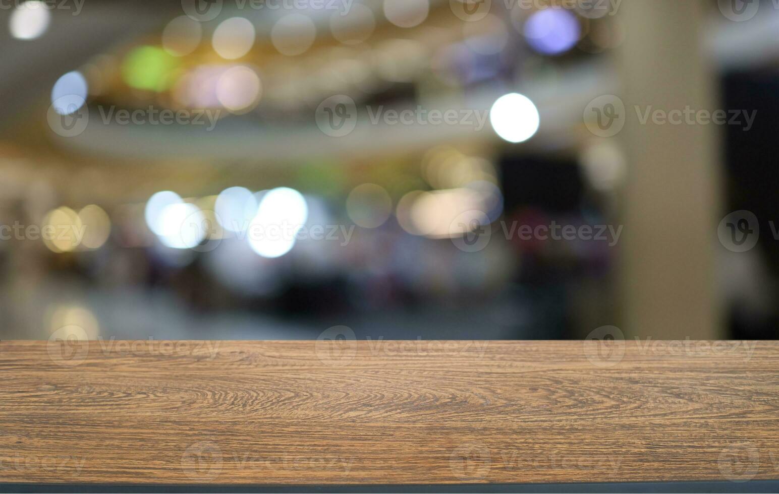 Empty wooden table in front of abstract blurred background of coffee shop . can be used for display or montage your products.Mock up for display of product photo