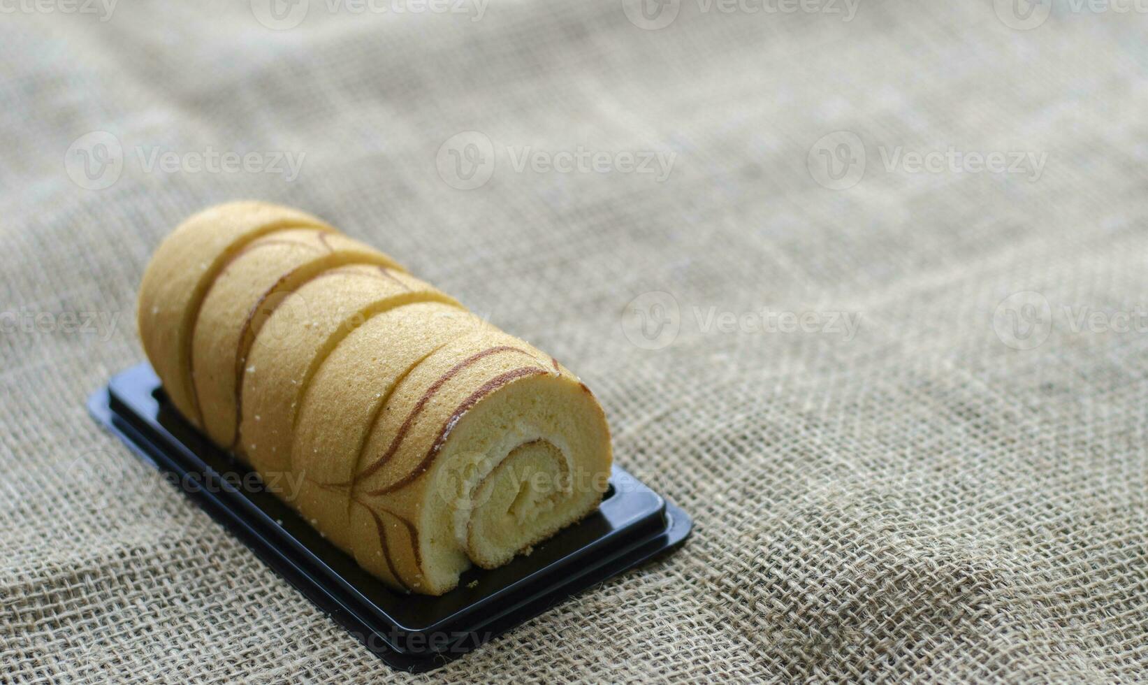 Mini vanilla roll cake, swiss roll cake or sponge roll with Vanilla flavor for a coffee break. Thai call Jam Rolls. with copy space photo