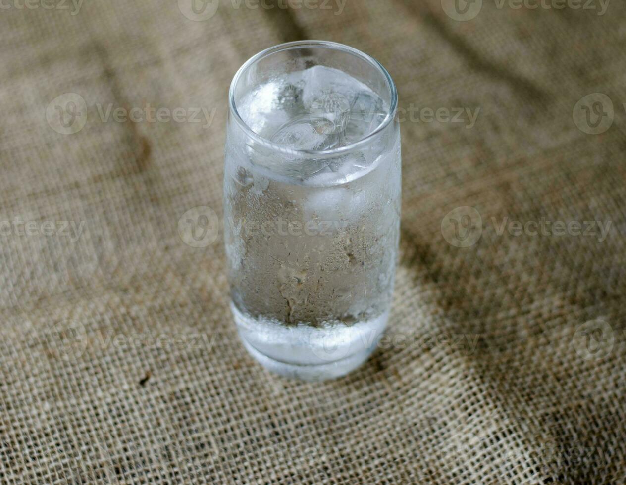 Close up, Cold drinking water with ice in a clean glass, drink healthy and cool down. photo