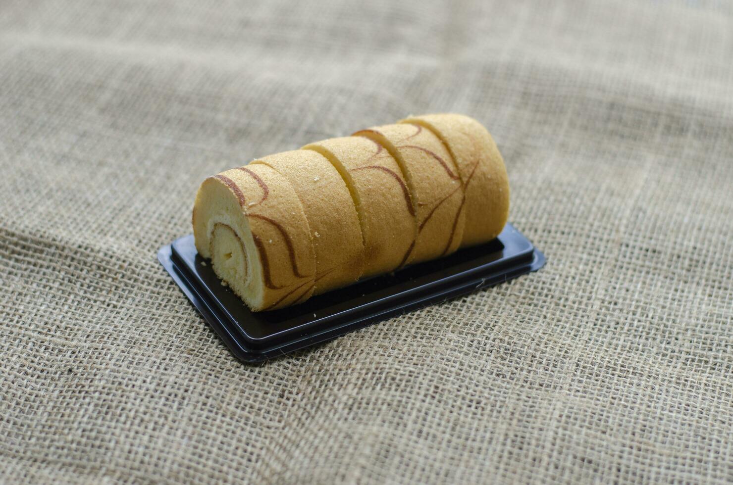 Mini vanilla roll cake, swiss roll cake or sponge roll with Vanilla flavor for a coffee break. Thai call Jam Rolls photo