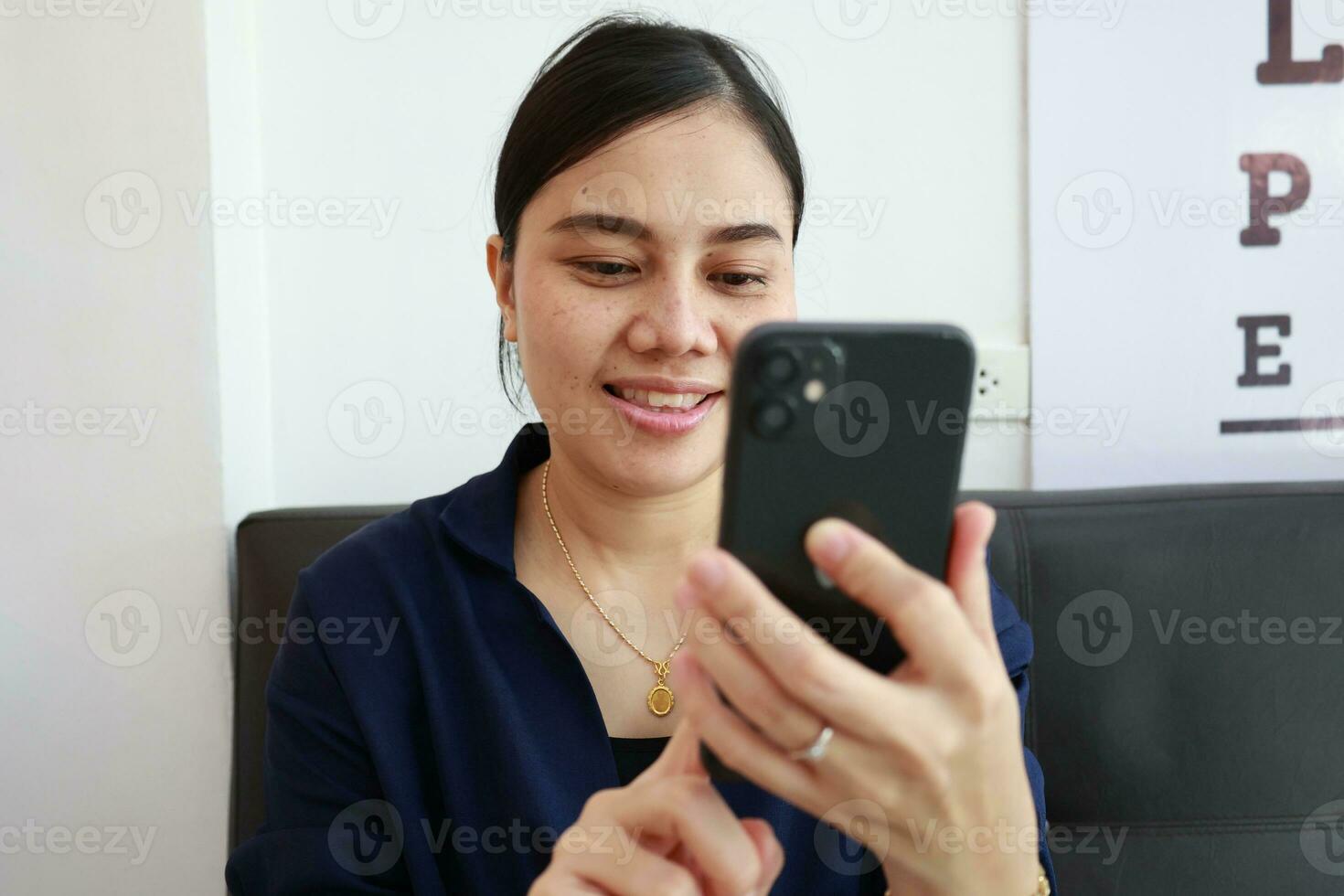 Person using phone, woman using mobile phone at home photo